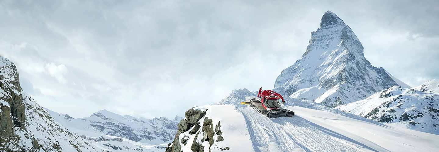 Snow groomer high in the Swiss Alps below the Matterhorn
